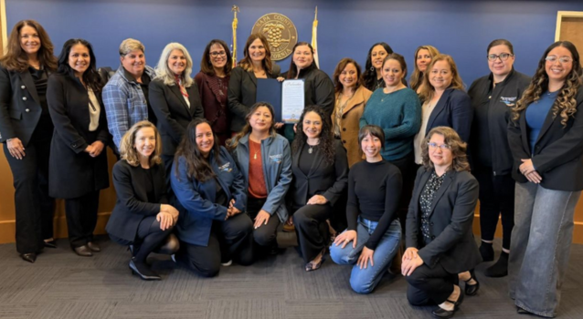 Group of people being honored at a meeting