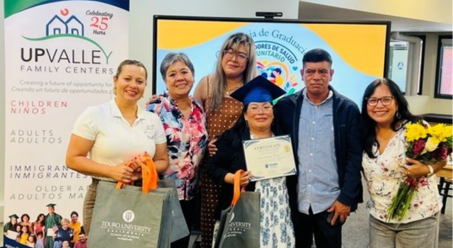 A member of Miel, the worker-owned cooperative incubated by UpValley Family Centers, displays her credentials from the Community Health Worker training.